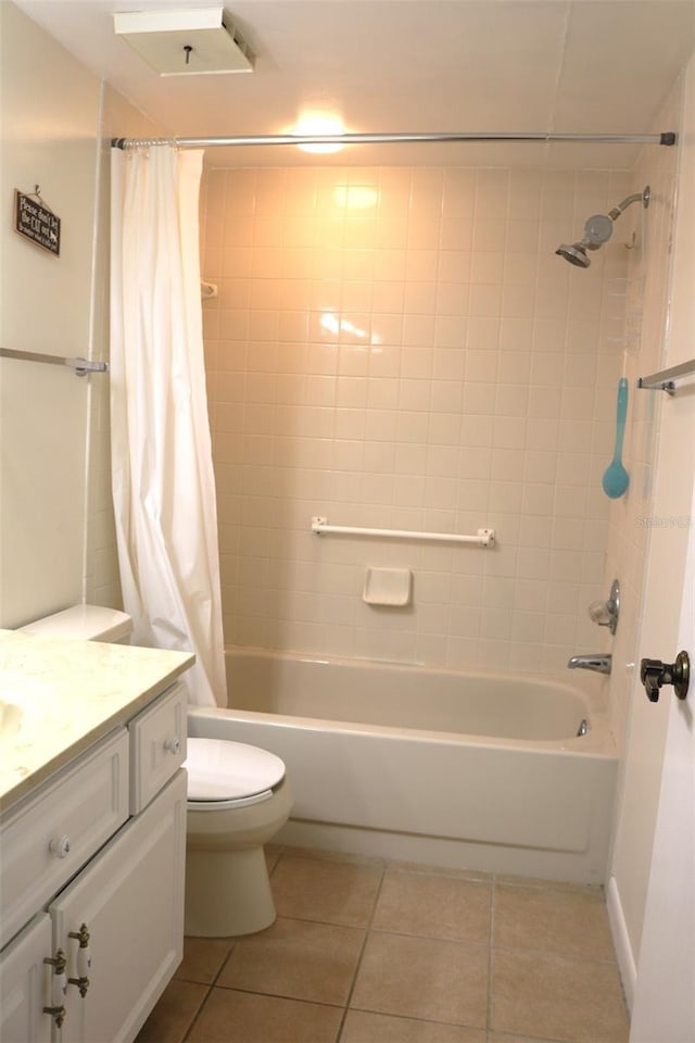 full bath featuring tile patterned flooring, toilet, vanity, and shower / bath combo