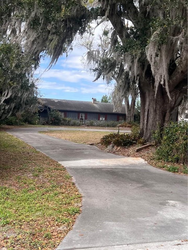 view of street featuring concrete driveway