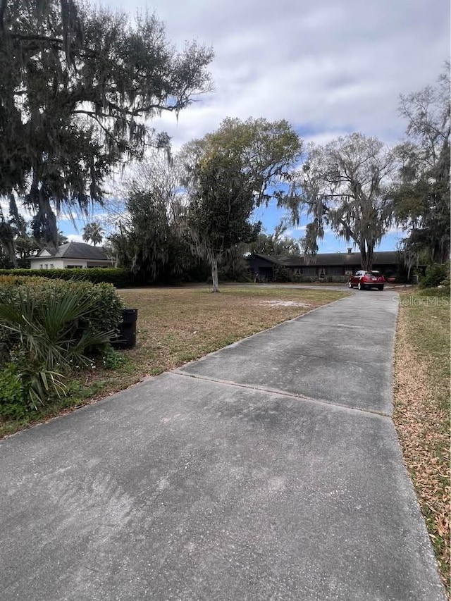 view of street featuring concrete driveway