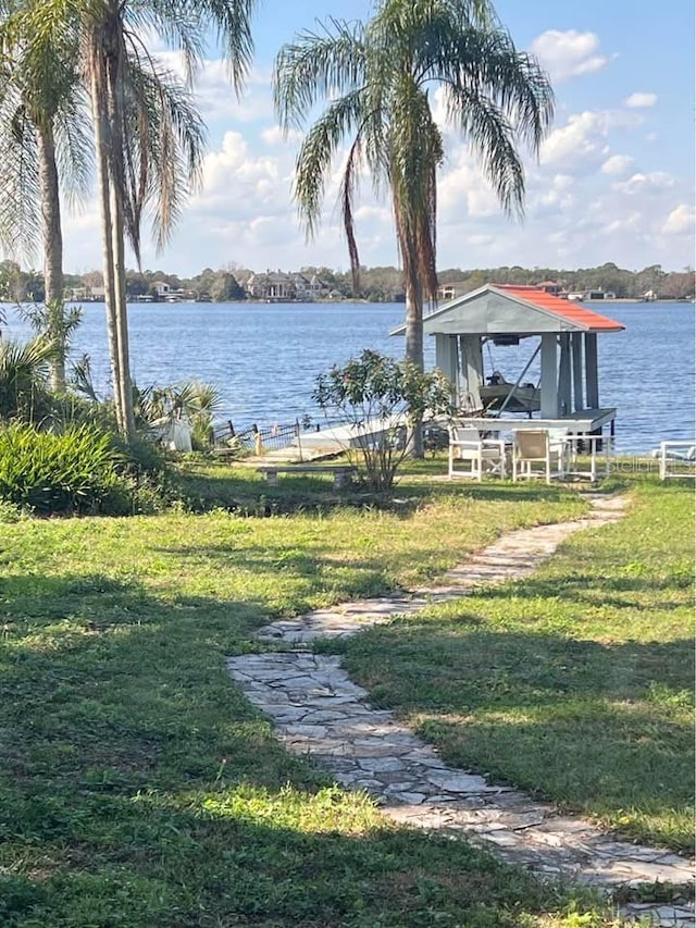 view of yard with a boat dock and a water view