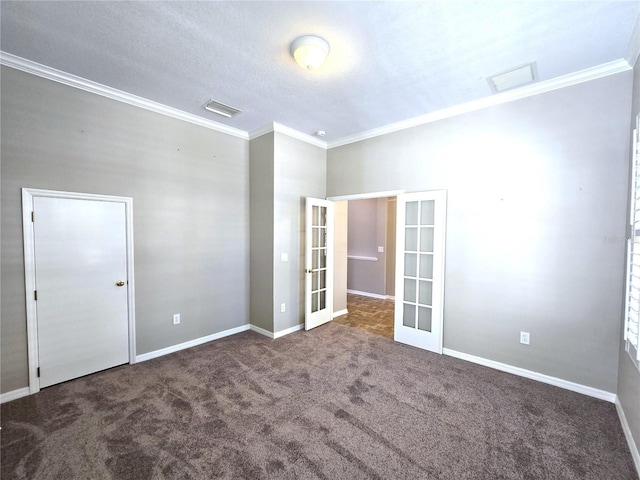 spare room featuring carpet, french doors, visible vents, ornamental molding, and baseboards