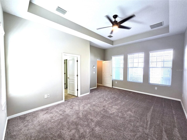 unfurnished bedroom featuring a raised ceiling and visible vents