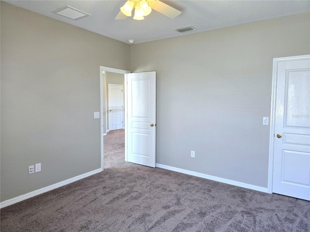 carpeted empty room with visible vents, ceiling fan, and baseboards