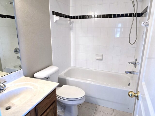 full bath with a textured wall, tile patterned flooring, toilet, vanity, and bathing tub / shower combination