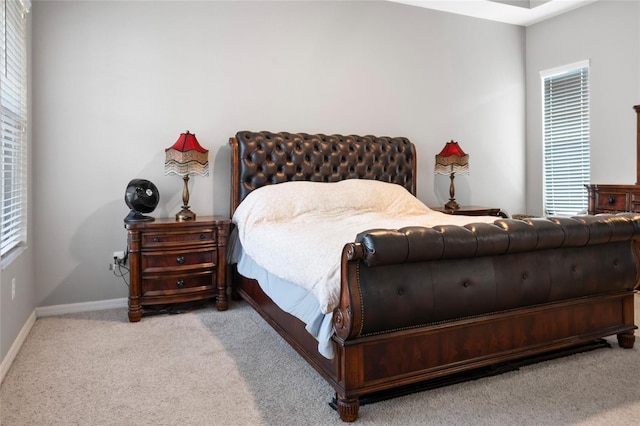 bedroom featuring carpet and baseboards