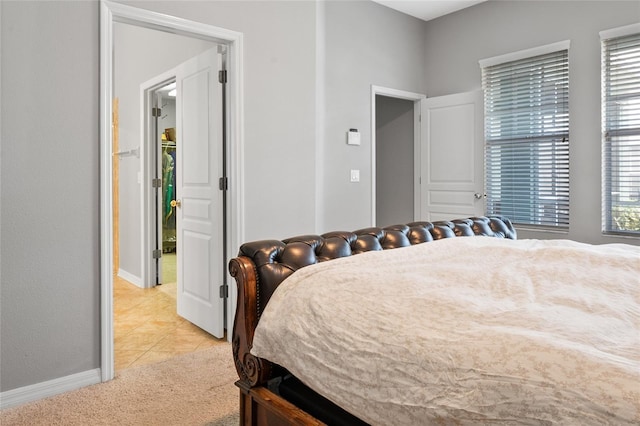 bedroom featuring light tile patterned floors and baseboards