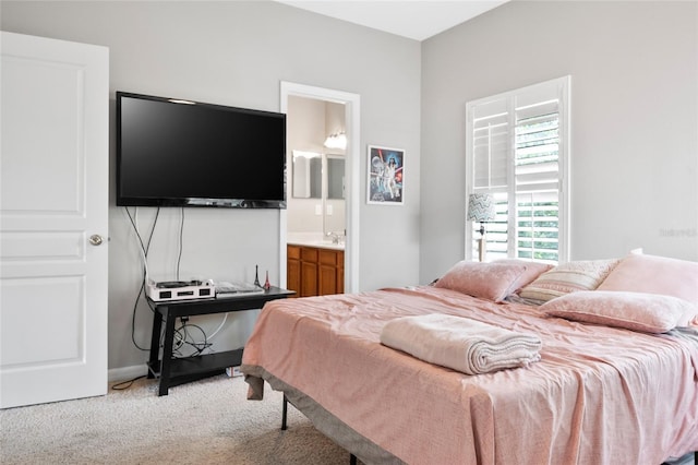 carpeted bedroom featuring ensuite bath