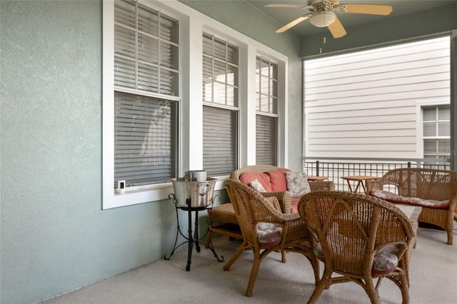 sunroom featuring ceiling fan