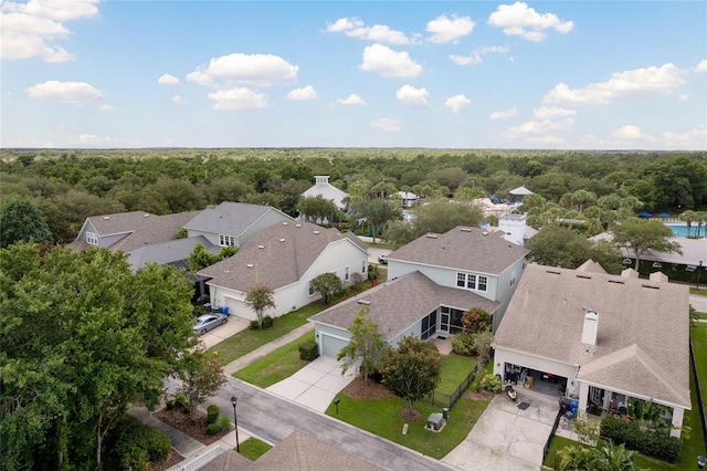 drone / aerial view with a residential view and a view of trees