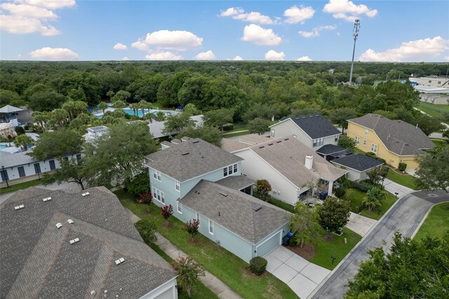 drone / aerial view with a residential view and a view of trees