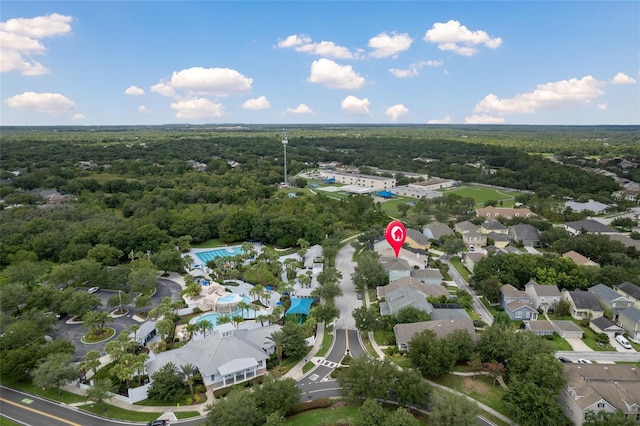 drone / aerial view featuring a forest view and a residential view