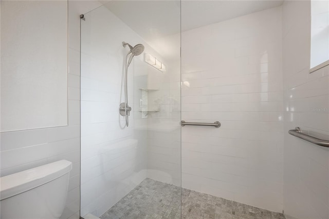 bathroom featuring toilet and a walk in shower