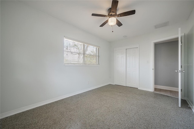 unfurnished bedroom featuring a ceiling fan, a closet, visible vents, and baseboards