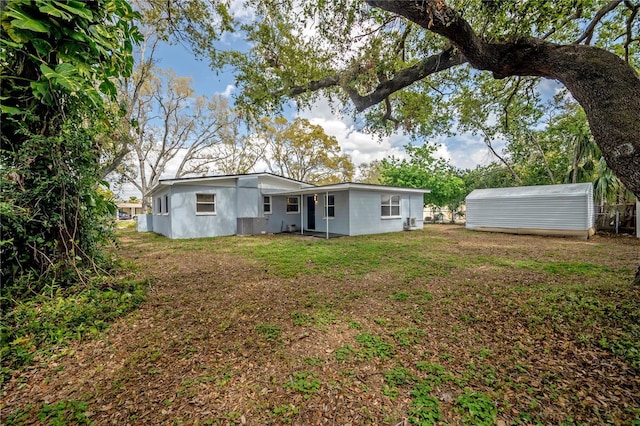 rear view of property with a yard