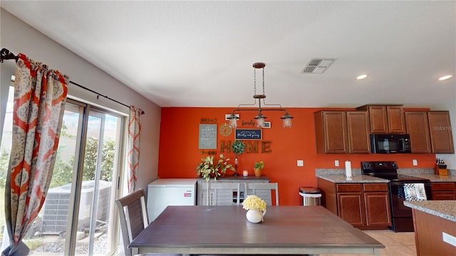 kitchen featuring black appliances, brown cabinetry, visible vents, and decorative light fixtures