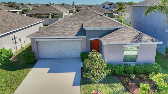 10115 Paradise Fish Dr, Riverview, FL 33578 - ranch-style home with a garage, roof with shingles, concrete driveway, and stucco siding