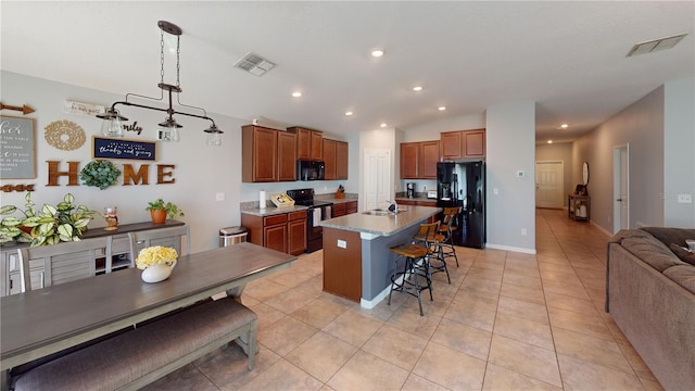 10115 Paradise Fish Dr, Riverview, FL 33578 - kitchen featuring a kitchen bar, black appliances, open floor plan, and visible vents