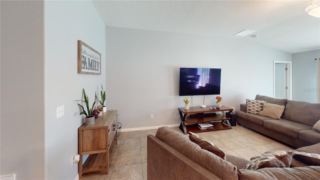 10115 Paradise Fish Dr, Riverview, FL 33578 - living area with baseboards, lofted ceiling, a textured ceiling, and light tile patterned flooring