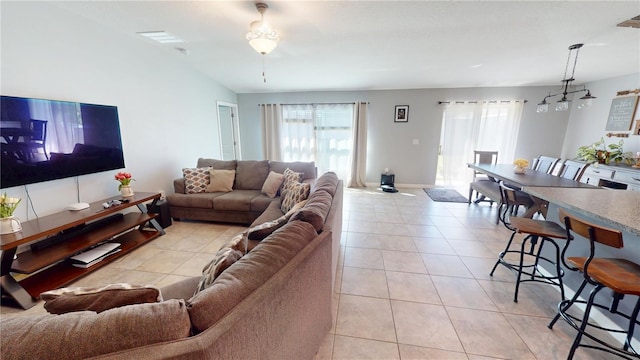 10115 Paradise Fish Dr, Riverview, FL 33578 - living room featuring a notable chandelier, light tile patterned floors, and vaulted ceiling