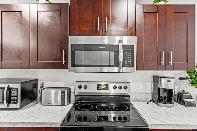 kitchen featuring stainless steel appliances and light countertops