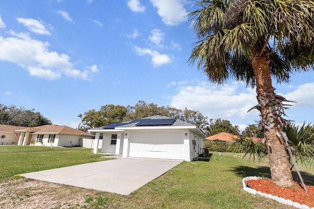 single story home featuring stucco siding, a front yard, roof mounted solar panels, a garage, and driveway