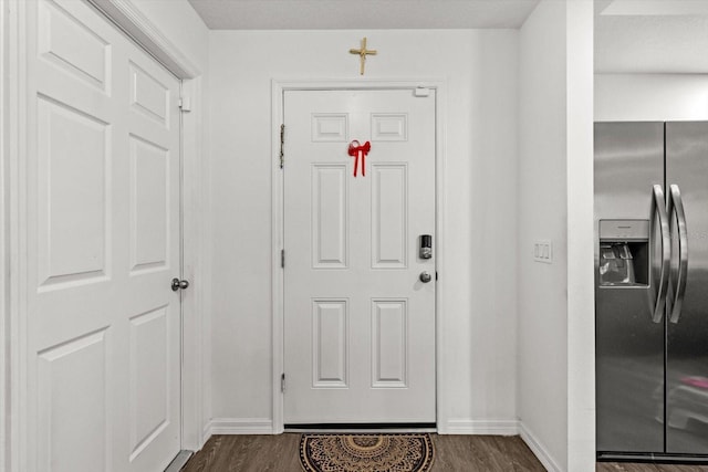 doorway to outside featuring dark wood finished floors and baseboards