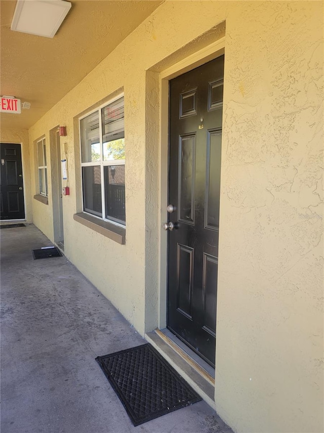 view of exterior entry with stucco siding