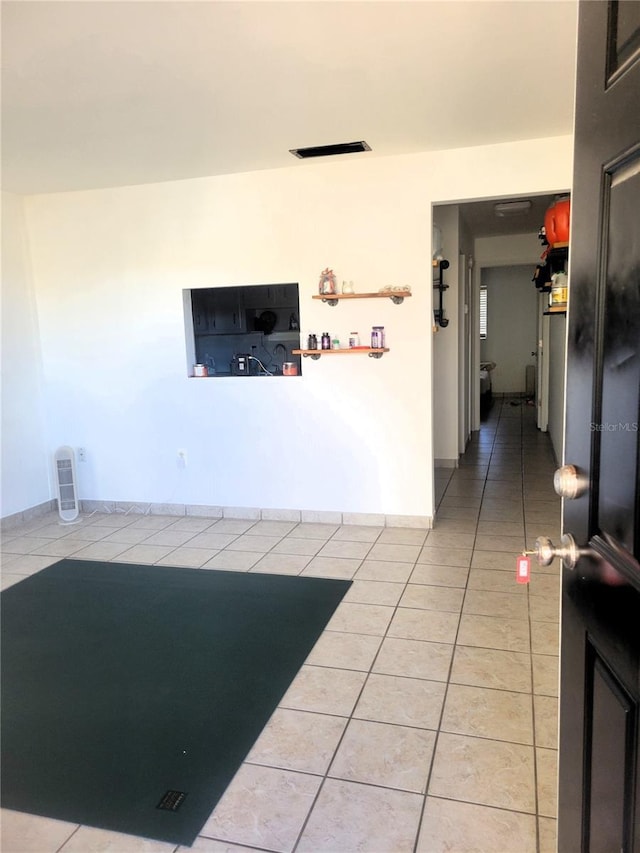 interior space featuring visible vents, baseboards, and light tile patterned floors