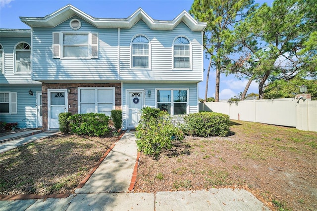 multi unit property with brick siding and fence