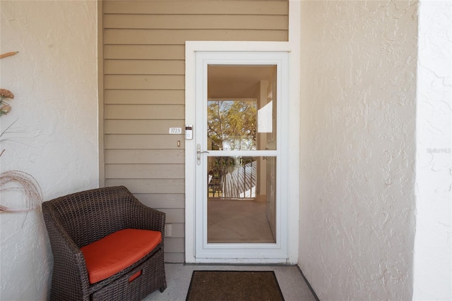 entrance to property featuring stucco siding