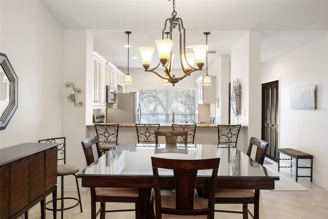 dining area featuring an inviting chandelier, light tile patterned floors, and visible vents