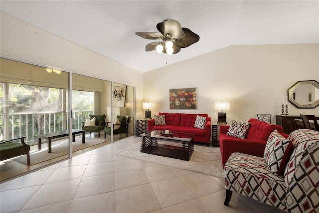 living room with tile patterned floors, a ceiling fan, and vaulted ceiling