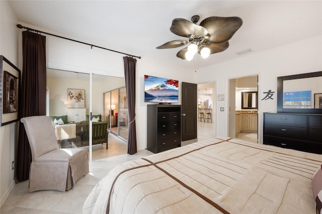 bedroom featuring ensuite bath, a ceiling fan, and visible vents