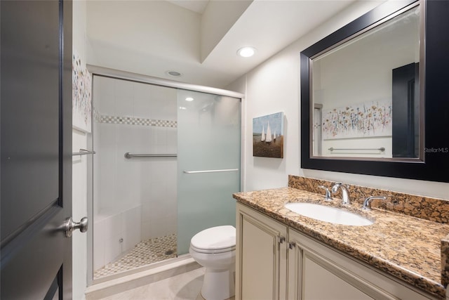 bathroom with vanity, a shower stall, toilet, and recessed lighting