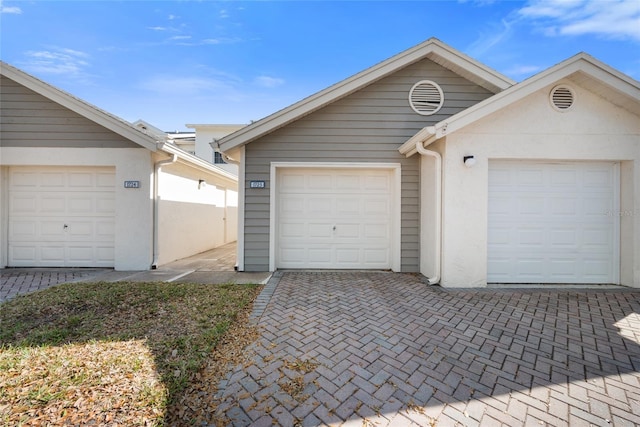 garage featuring decorative driveway