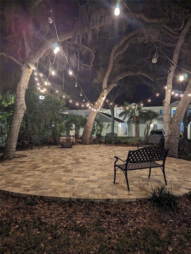 yard at twilight featuring a patio