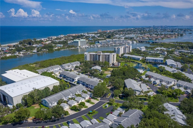 drone / aerial view featuring a city view and a water view