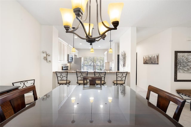 dining space with recessed lighting and a chandelier