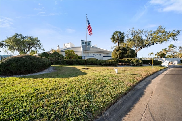 view of home's community with a lawn