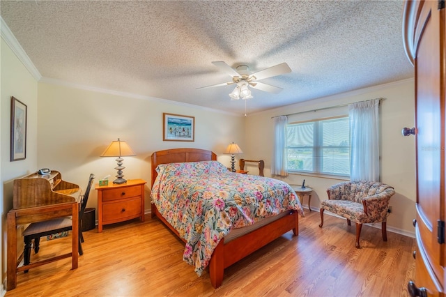 bedroom with a textured ceiling, light wood-type flooring, and ornamental molding