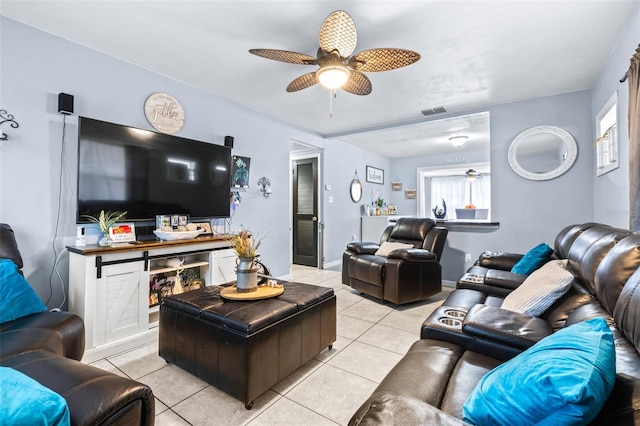 living room featuring visible vents, ceiling fan, baseboards, and light tile patterned floors