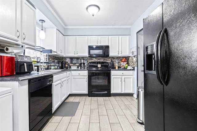 kitchen featuring black appliances, white cabinetry, and a sink