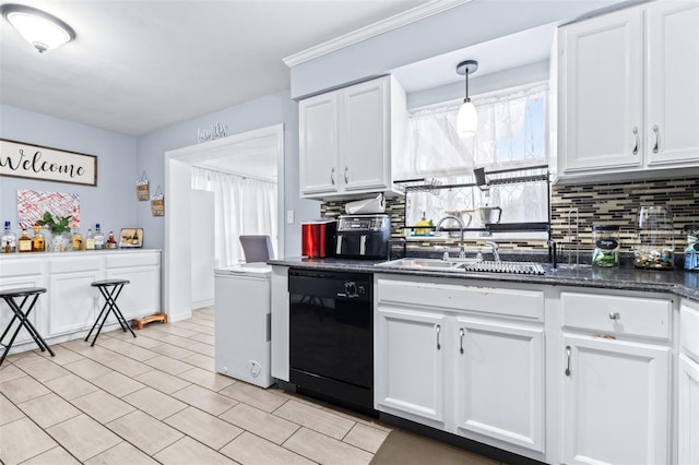 kitchen with dishwasher, a sink, white cabinetry, and decorative backsplash