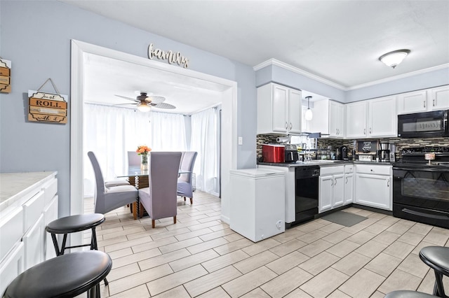 kitchen with ceiling fan, white cabinets, black appliances, tasteful backsplash, and crown molding