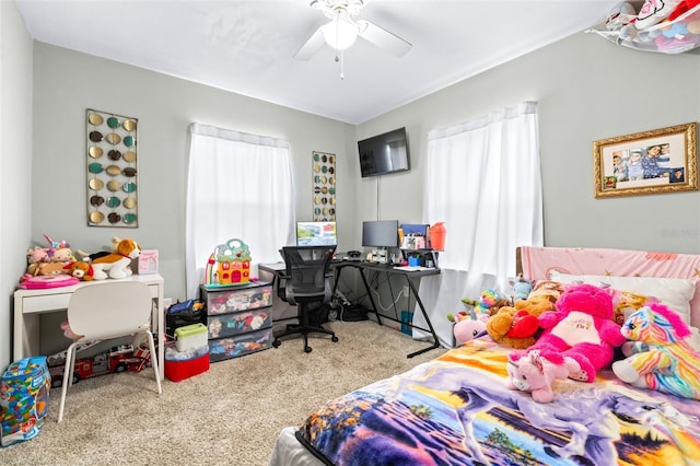 carpeted bedroom featuring ceiling fan and multiple windows