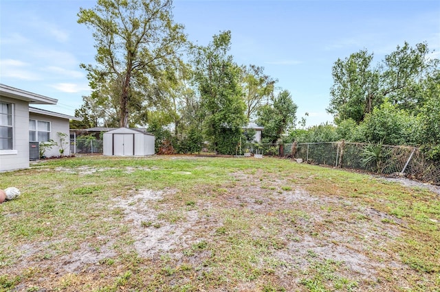 view of yard with a storage shed, an outdoor structure, and a fenced backyard