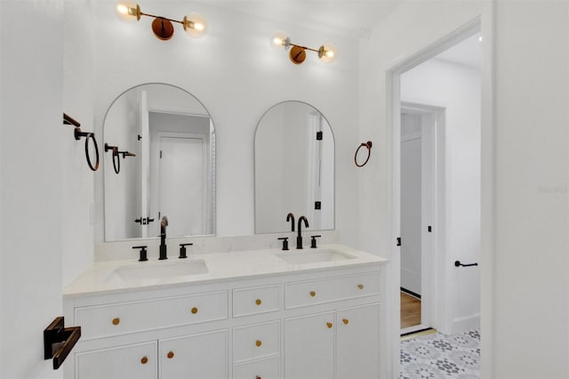 full bathroom with double vanity and a sink