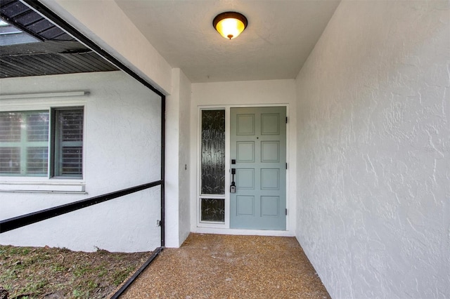 doorway to property with stucco siding