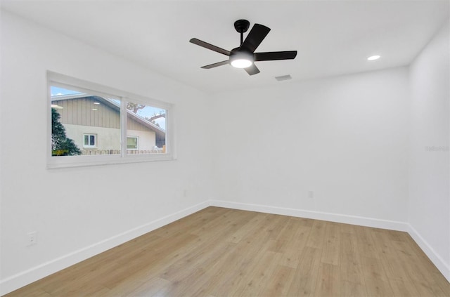 empty room featuring a ceiling fan, baseboards, wood finished floors, and recessed lighting