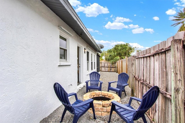 view of patio with a fenced backyard and a fire pit